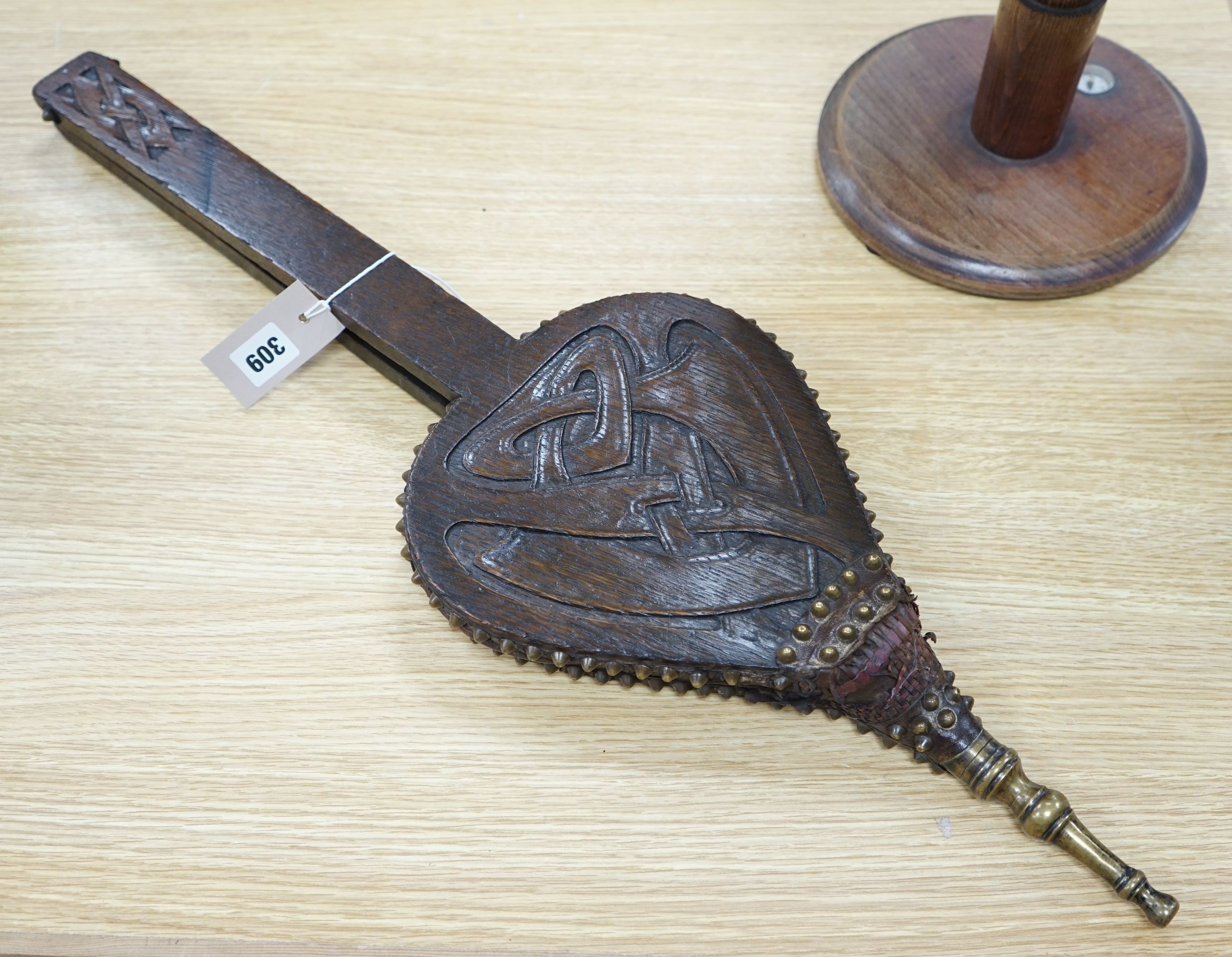 A carved oak Otley bellows, designed by A Knox for Liberty & Co. 75cms high